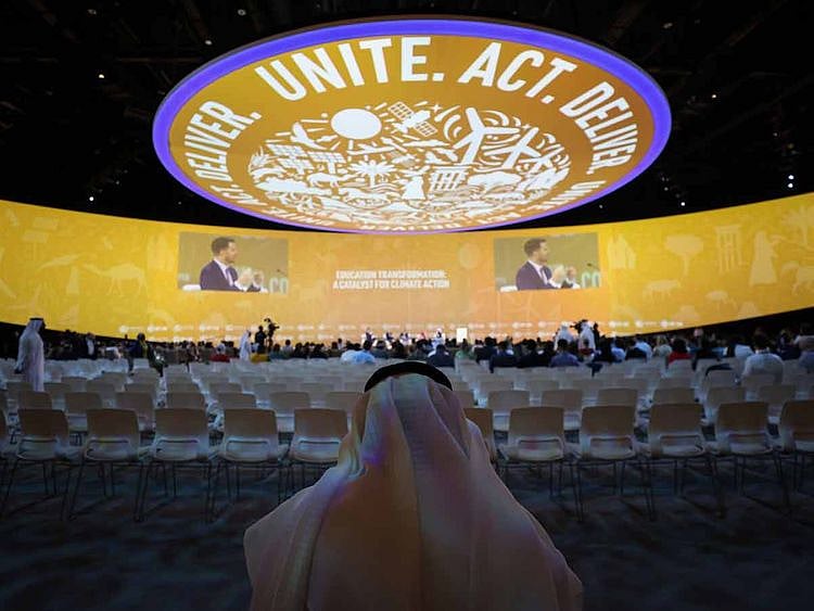 An attendee inside a panel session on day three of the COP28 climate conference at Expo City in Dubai, United Arab Emirates, on Saturday, Dec. 2, 2023.