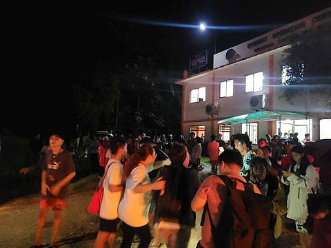 People gather, in the aftermath of an earthquake, in Hinatuan, Surigao del Sur, Philippines December 2, 2023. 
