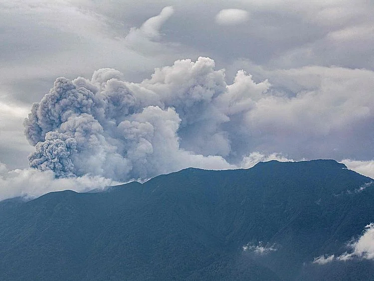 Volcanic ash spews from Mount Marapi during an eruption as seen from Tanah Datar in West Sumatra on December 3, 2023.  