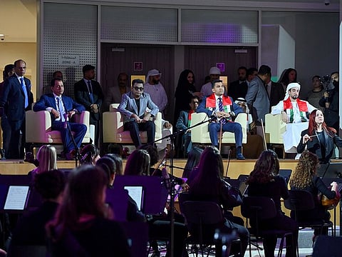 A.R. Rahman and Dr Shamhseer Vayalil, Founder and Chairman of Burjeel Holdings, watching Firdaus Orchestra's performance at Burjeel Medical-City