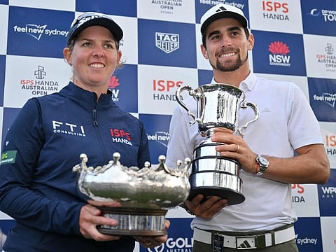 South Africas Ashleigh Buhai (left) holds the and Chiles Joaquin Niemann with their trophies after they won the Australian Open at The Australian Golf Club in Sydney on Sunday.