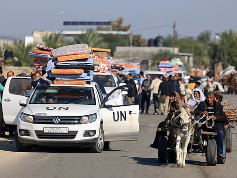 United nations employees and Palestinian civilians flee Khan Younis in the southern Gaza Strip after the Israeli army called on people to leave certain areas in the city, as battles between Israel and Hamas militants continue on December 3, 2023.  