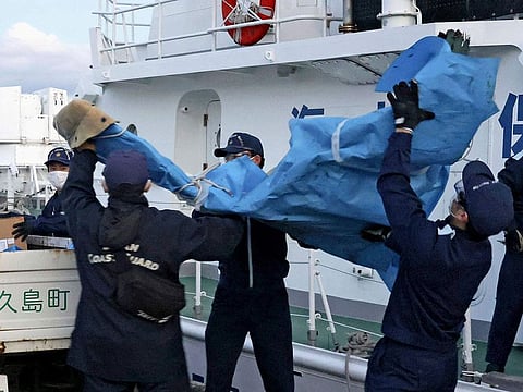 The members of Japanese Coast Guard carry the debris which are believed to be from the crashed U.S. military Osprey aircraft, at a port in Yakushima, Kagoshima prefecture, southern Japan, Monday, Dec. 4, 2023. 