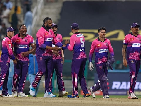 New York Strikers players celebrate a wicket at the Sheikh Zayed Stadium in Abu Dhabi on Monday.