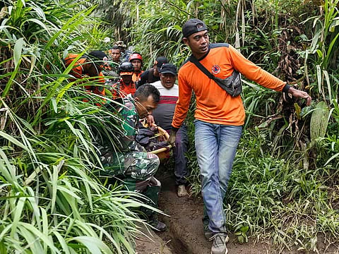Rescuers carry away a victim after the eruption of Mount Marapi in Agam, West Sumatra.