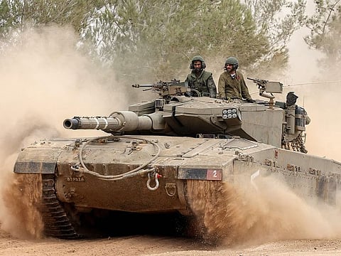 An Israeli military tank rolls near the border with the Gaza Strip on December 5, 2023, amid continuing battles between Israel and the militant group Hamas.