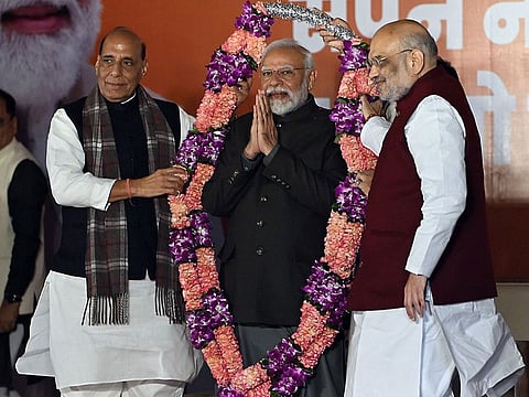 Narendra Modi, India's prime minister, receives a garland at the Bhartiya Janata Party (BJP) headquarters in New Delhi, India, on Sunday, Dec. 3, 2023. India’s ruling Bharatiya Janata Party won three crucial state elections and unseated the opposition in two of them, strengthening Modi’s bid for a third term in office. 