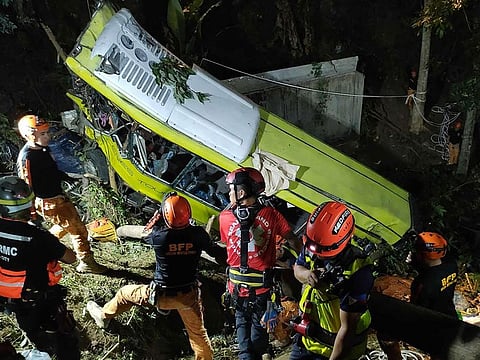 Rescue personnel working at the scene where a bus plunged into a ravine in Hamtic town, Antique province.