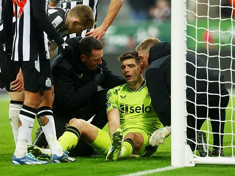 Newcastle United's Nick Pope receives medical attention after sustaining an injury during a Premier League match against Manchester United on December 2.