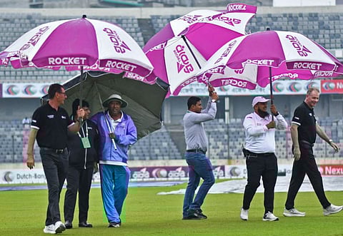 Umpires and officials inspect the field as rain washed out the second day of play during the second Test match between Bangladesh and New Zealand at the Sher-E-Bangla National Cricket Stadium in Dhaka on Thursday.