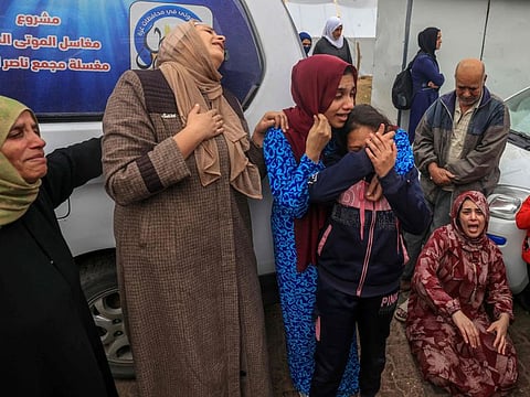 Palestinians mourn the death of loved ones following Israeli bombardment in the southern Gaza Strip on December 5, 2023, outside a hospital in Khan Younis, amid continuing battles between Israel and the militant group Hamas.  