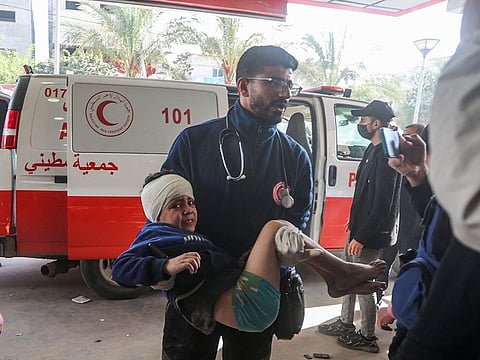 An injured Palestinian chid is carried into a hospital following Israeli bombardment on Khan Yunis in the southern Gaza Strip on December 8, 2023, amid continuing battles between Israel and the Palestinian militant group Hamas. 