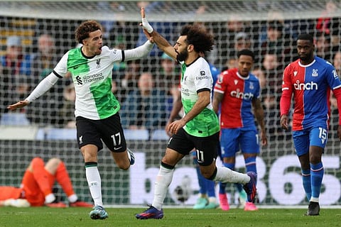 Liverpool's Egyptian striker Mohamed Salah celebrates with Curtis Jones after scoring their first goal during the Premier League match against Crystal Palace at Selhurst Park in south London on Saturday..