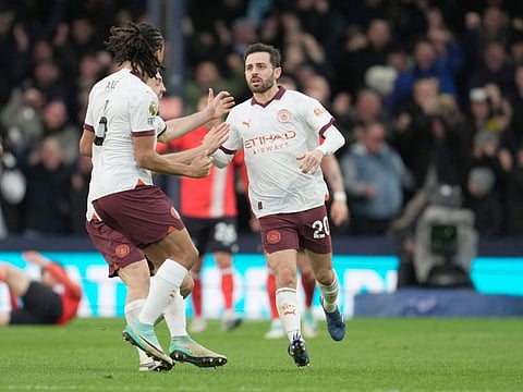 Manchester City's Bernardo Silva is congratulated after scoring his side's first goal during the English Premier League match against Luton Town at Kenilworth Road stadium in Luton on Sunday.