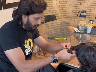 Bollywood actor Riteish Deshmukh gives his son a haircut