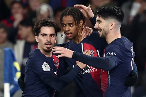 Paris Saint-Germain's French forward Bradley Barcola (centre) is congratulated by midfielders Vitinha and Carlos Soler during a match against Nantes on December 9.