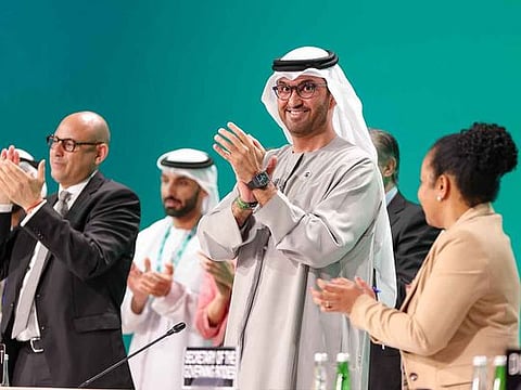 Dr. Sultan Al Jaber, COP28 President, Simon Stiell, Executive Secretary of the UNFCCC and other delegates applaud onstage during the Closing Plenary at the UN Climate Change Conference COP28 at Expo City Dubai on December 13, 2023, in Dubai, United Arab Emirates. 
