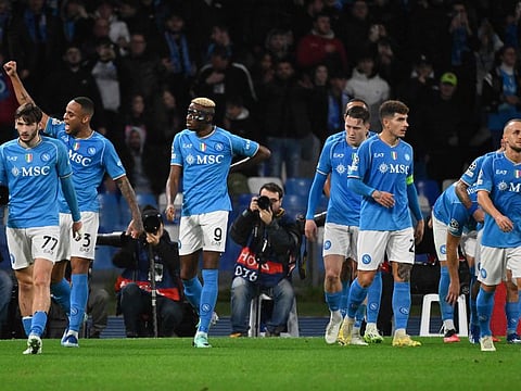 Napoli's Nigerian forward #09 Victor Osimhen (centre) celebrates with teammates after scoring the team's second goal during the Uefa Champions League match against Sporting Braga at the Diego Armando Maradona stadium in Naples on Tuesday.