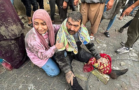 Palestinians after an Israeli air strike hit their homes in Rafah in the southern Gaza Strip i=on December 12, 2023.  