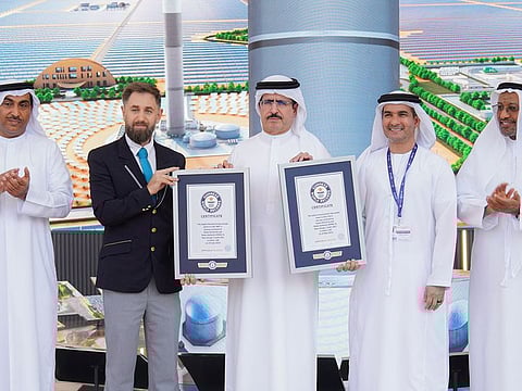 Saeed Mohammed Al Tayer, MD & CEO of DEWA, receiving the two world record certificates from Guinness World Records representatives in Dubai.