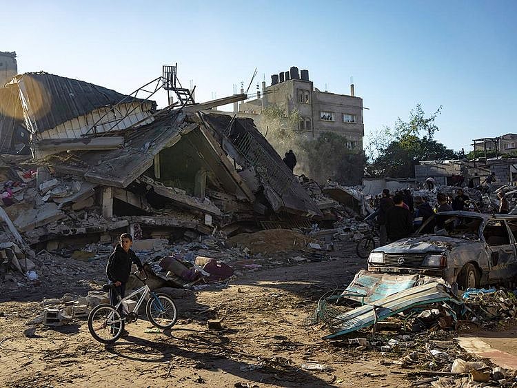 Palestinians search for bodies and survivors in the rubble of a residential building