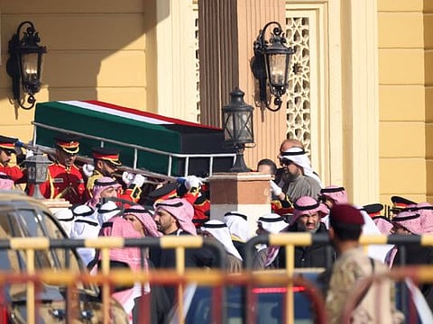 The coffin of Sheikh Nawaf is carried out of the Bilal bin Rabah Mosque in Kuwait City ahead of burial during his funeral on December 17, 2023.  