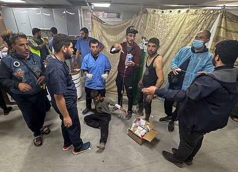 Medics care for an injured youth at Al Shifa hospital as battles continue between Israel and the militant group Hamas in Gaza.  