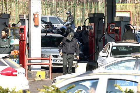 People wait at a gas station in Tehran on December 18, 2023 as fuel distribution across 70 per cent of Iran's gas stations is disrupted.  