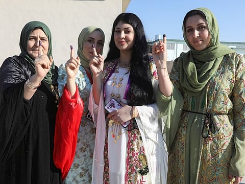 Kurdish women who cast their votes during Iraq's provincial council elections, at a polling station in Kirkuk, on December 18, 2023. 