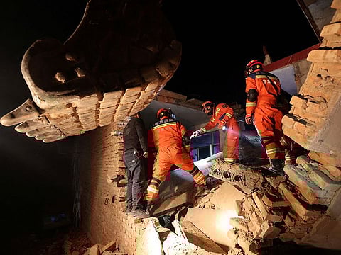 Rescue workers conduct search and rescue operations at Kangdiao village following the earthquake in Jishishan county, Gansu province, China.