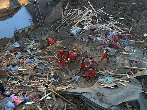 Rescuers search a collapsed building in Caotan village of Minhe Hui and Tu Autonomous County in Haidong City, northwestern China's Qinghai Province.