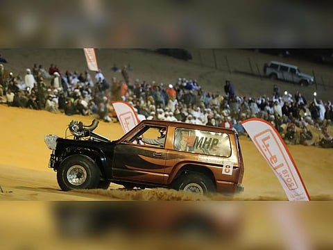 File photo of a contender at Liwa. A race up the 50-degree-slant on the dune's slipface is one of the highlights of the festival.   