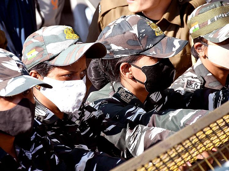 Women security personnel with face masks after cases of COVID-19 sub-variant JN.1 were detected in the country, in Guwahati.   