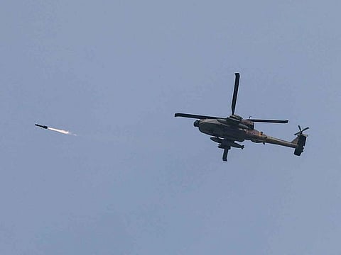 An Israeli military Apache helicopter fires a missile near Israel-Gaza border.