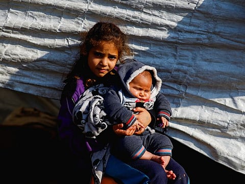 Displaced Palestinians, who fled their houses due to Israeli strikes, shelter in a tent camp, amid the ongoing conflict between Israel and the Palestinian Islamist group Hamas, in Rafah in the southern Gaza Strip, on December 26, 2023.  