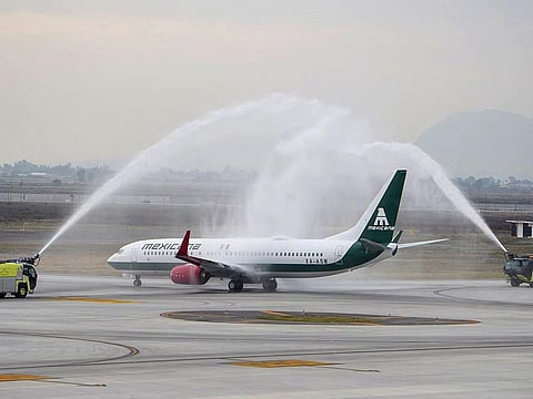 A plane of former state airline Mexicana de Aviacion receives a water salute before taking off from the military-run Felipe Angeles International Airport (AIFA) in Zumpango, Mexico, December 26, 2023.  