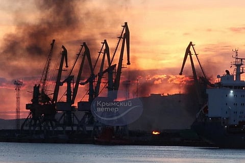 This photograph posted on the Telegram channel @VentdeCrimee on December 26, 2023 shows smoke rising above a damaged warship following a Ukrainian attack in the port of Feodosiya, Crimea.  