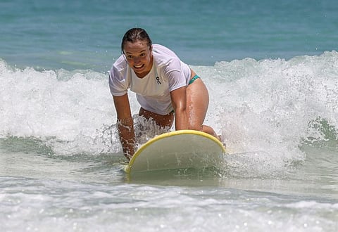 Polands Iga Swiatek takes part in a learn to surf promotional event at Scarborough Beach in Perth on Thursday.