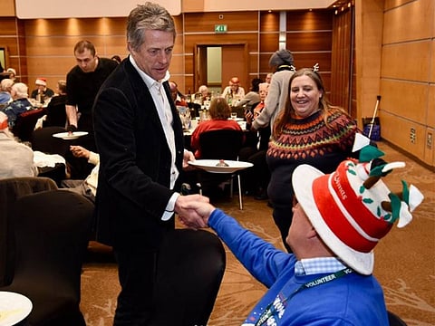 Hugh Grant interacts with residents.