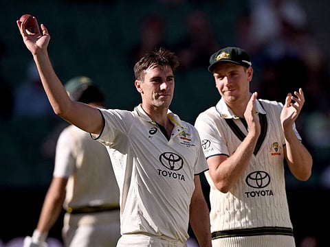 Australian bowler Pat Cummins (left) acknowledges the cheers after taking five wickets on the fourth day of the second Test against Pakistan in Melbourne.