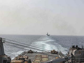 In this image provided by the US Navy, the amphibious dock landing ship USS Carter Hall and amphibious assault ship USS Bataan transit the Bab Al Mandab strait on August 9, 2023.