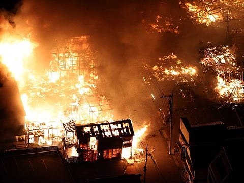 This aerial photo shows buildings burning in the city of Wajima, Ishikawa prefecture on January 1, 2024, after a major 7.5 magnitude earthquake struck the Noto region in Ishikawa prefecture in the afternoon.  