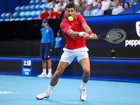 Serbia's Novak Djokovic hits a return against Australia's Alex de Minaur during their men's singles match at the United Cup tennis tournament in Perth on Wednesday.