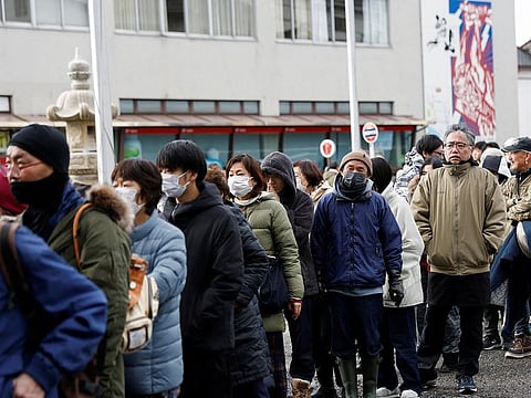 Residents stand in a line to get food from a volunteer group, in the aftermath of an earthquake, in Wajima, Ishikawa Prefecture, Japan, January 4, 2024. 
