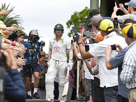 Fans cheer on Australia’s David Warner as he walks out to bat for the last time in his 112th and farewell Test during day four of the third cricket Test match against Pakistan at the Sydney Cricket Ground in Sydney on January 6, 2024. 