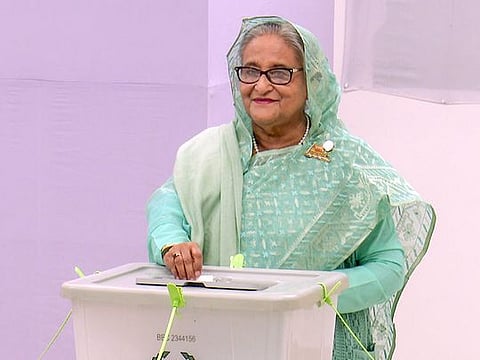 Election officials prepare to count votes in Dhaka.
