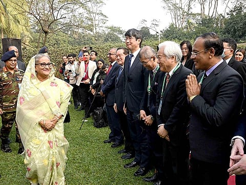 In this photograph released by Bangladesh Prime Minister's office, Prime Minister Sheikh Hasina, left, arrives to address a press conference following her election victory in Dhaka, Bangladesh, Monday, Jan 8, 2024