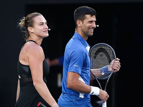 Aryna Sabalenka from Belarus and Serbia’s Novak Djokovic play mixed-doubles together during a charity event on Rod Laver Arena in Melbourne on January 11, 2024 ahead of the Australian Open tennis championship starting on January 14. 