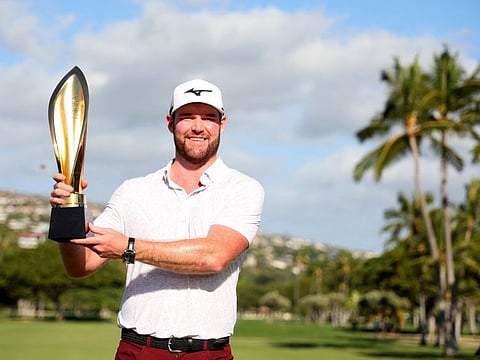 Grayson Murray of the US trophy after winning the Sony Open on the first play-off hole in Hawaii on Sunday.
