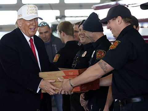 Trump delivers pizza to fire fighters at Waukee Fire Department in Waukee, Iowa, on January 14, 2024.  